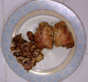 Chicken with rosemary, and mushrooms on the side.