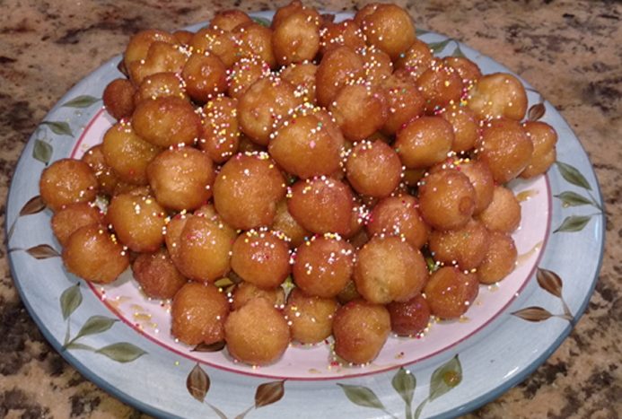 Struffoli, sweet fried dough balls covered in honey and sprinkles