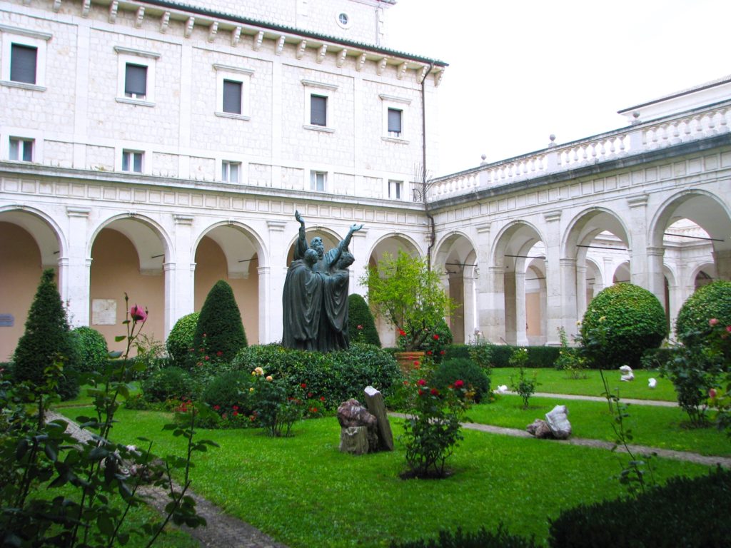 Monte Cassino Courtyard with statue of St. Benedict receiving Holy Communion