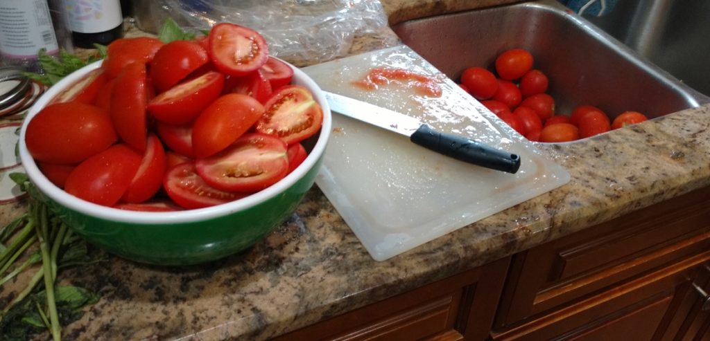 Cutting the tomatoes to make it easier to grind.